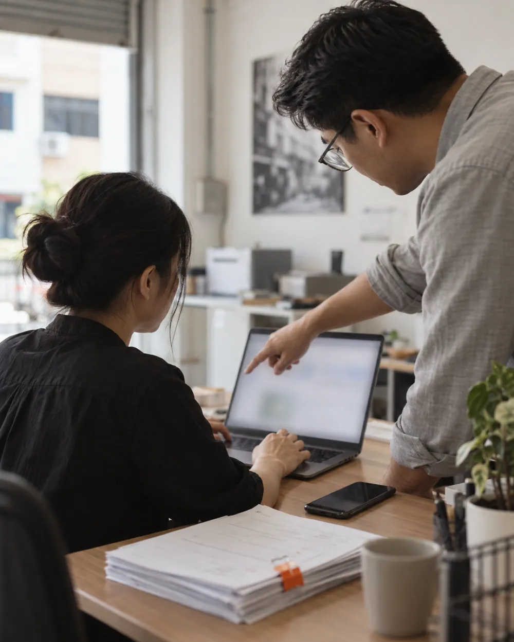 A consultant reviewing work on screen